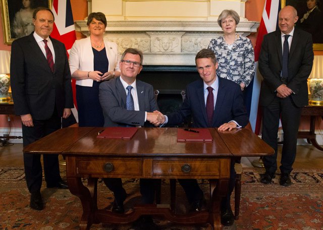 britain 039 s conservative party leader and prime minister theresa may 2r stands with britain 039 s first secretary of state damian green r democratic unionist party dup leader arlene foster 2l dup deputy leader nigel dodds l as dup mp jeffrey donaldson 3l shakes hands with britain 039 s parliamentary secretary to the treasury and chief whip gavin williamson after signing paperwork inside 10 downing street in central london on june 26 2017 photo afp