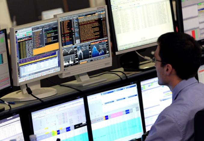 a trader looks at his screens on the unicredit bank trading floor in downtown milan photo reuters