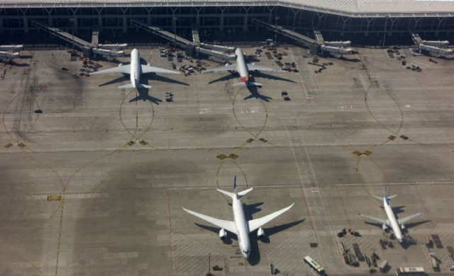 the elderly woman was detained by police at shanghai pudong international airport following the bizarre incident forcing nearly 150 passengers to be evacuated from the plane bound for guangzhou in southern china photo afp the elderly woman was detained by police at shanghai pudong international airport following the bizarre incident forcing nearly 150 passengers to be evacuated from the plane bound for guangzhou in southern china photo afp