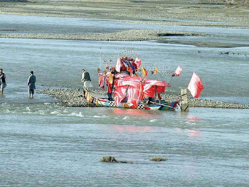 people wet their feet in the cold water of khiayali river photo app