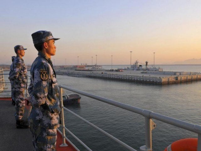 chinese naval soldiers stand guard on china 039 s first aircraft carrier liaoning as it travels towards a military base in sanya hainan province photo reuters