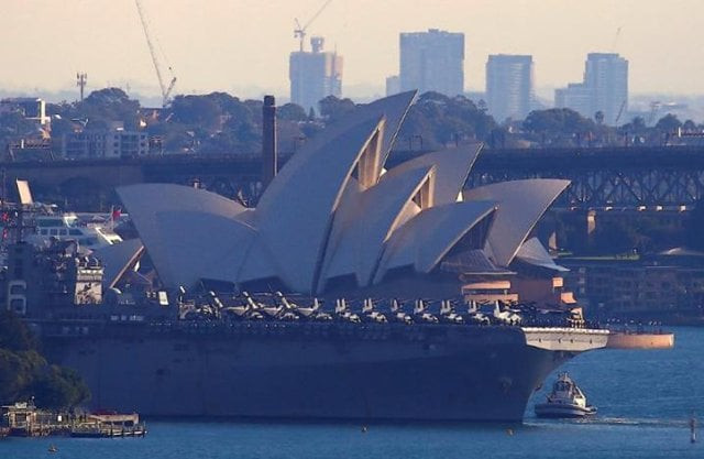 the uss bonhomme richard amphibious assault ship manoeuvres into port in front of the sydney opera house in australia june 29 2017 after a ceremony on board the ship marking the start of talisman saber 2017 a biennial joint military exercise between the united states and australia photo reuters
