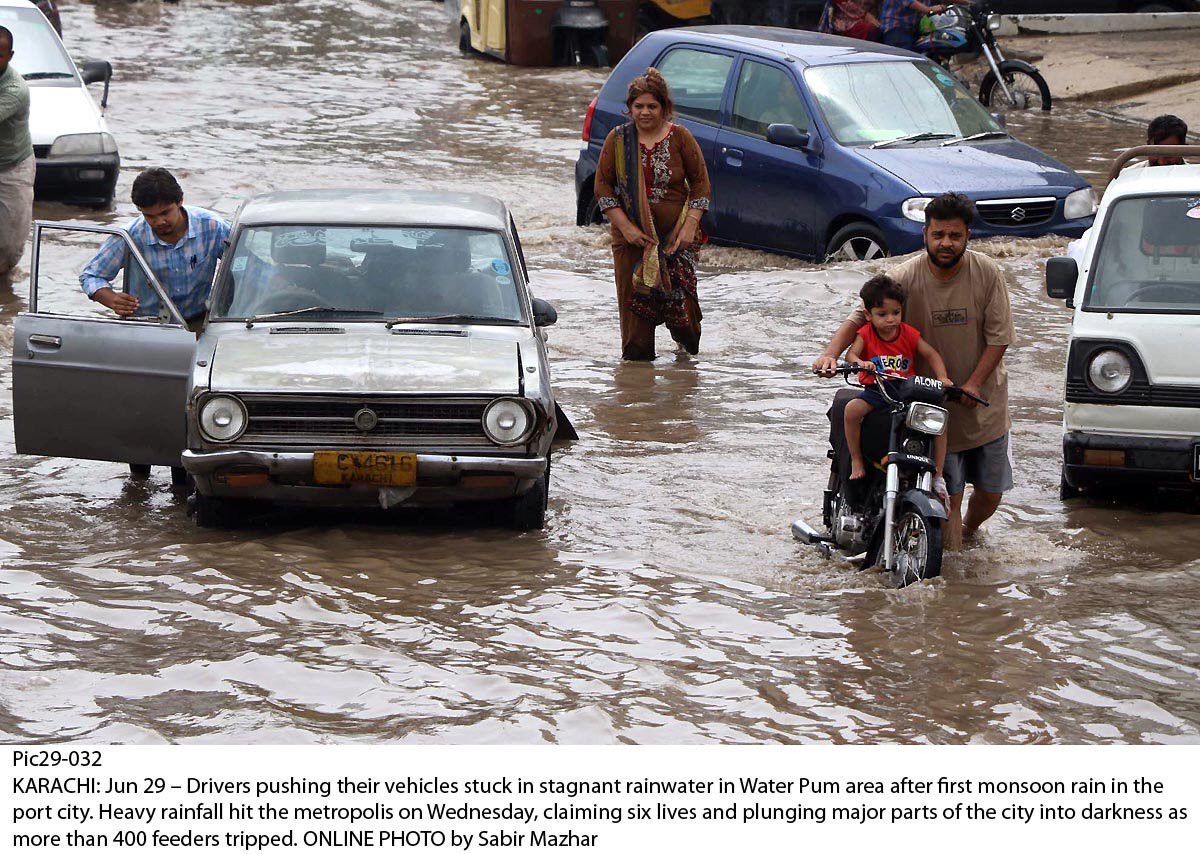 wreaking havoc drivers push their vehicles stuck in stagnant water near karachi s water pump area photo online