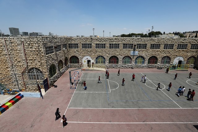 palestinian children play on a court at a school in the east jerusalem neighbourhood of silwan photo reuters