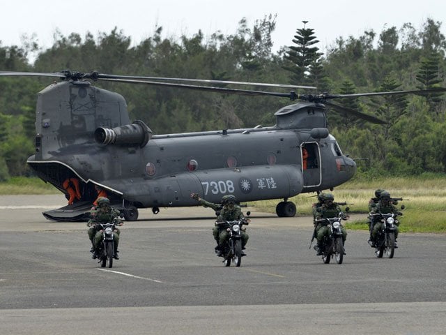 this file photo taken on may 25 2017 shows armed taiwanese soldiers riding on motorcycles next to a us made ch 47 helicopter during the quot han kuang quot han glory life fire drill some 7 kms 4 miles from the city of magong on the outlying penghu islands photo afp