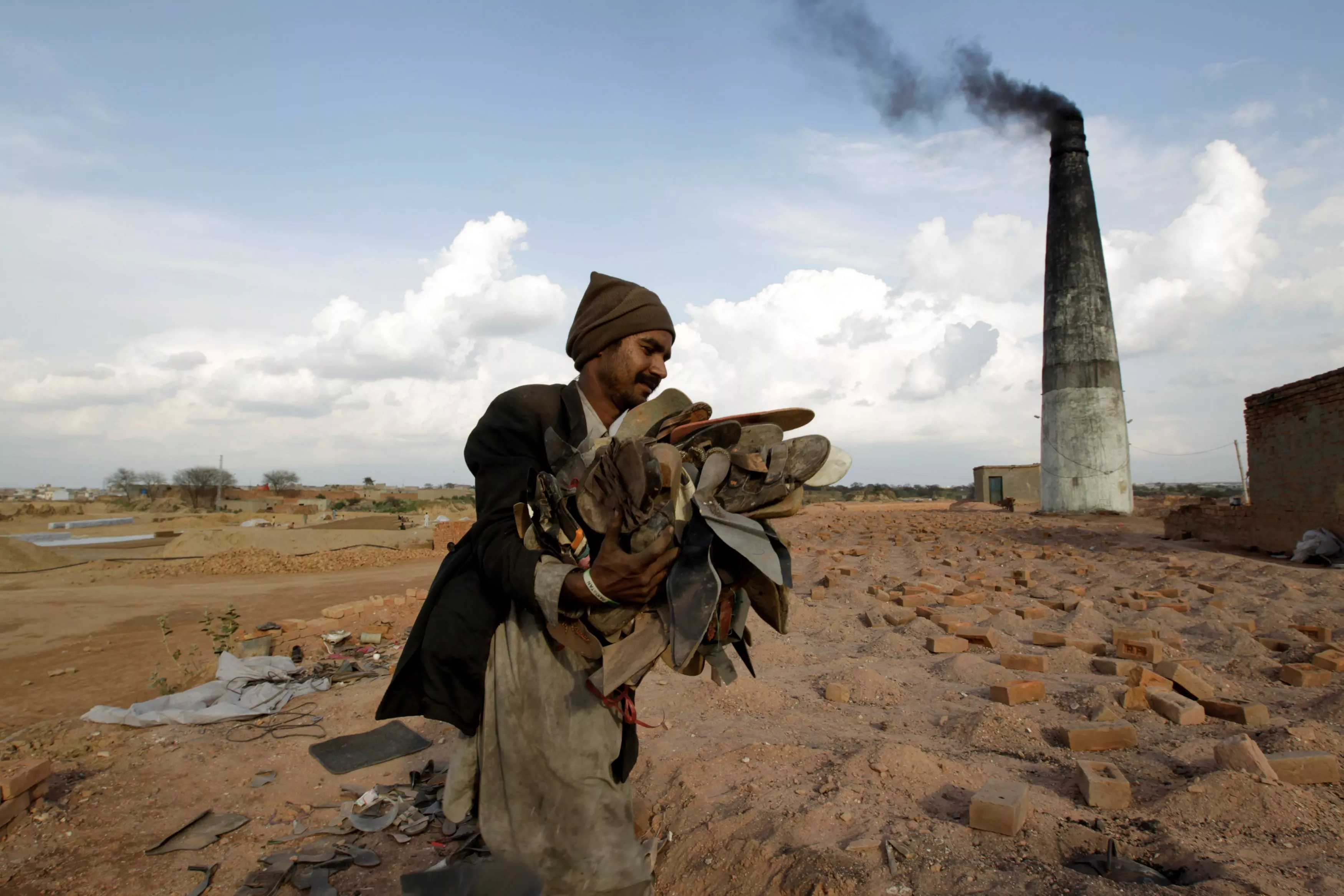 a worker carries shoes to be burned in the kiln of a brick factory in islamabad pakistan march 9 2017 photo reuters a worker carries shoes to be burned in the kiln of a brick factory in islamabad pakistan march 9 2017 photo reuters