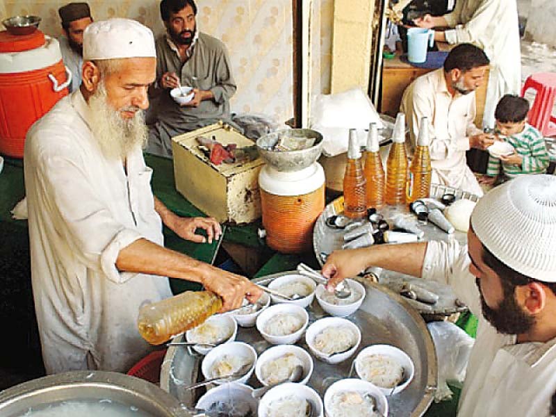 amir gul douses kulfi falooda with honey coloured syrup at his store in yakatoot photo muhammad iqbal express