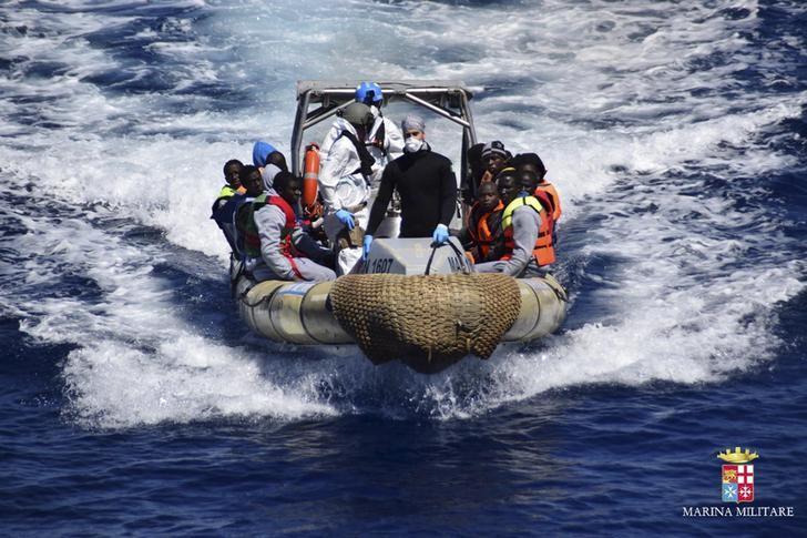 migrants sit in a rescue boat during a rescue operation by italian navy vessels off the coast of sicily photo reuters