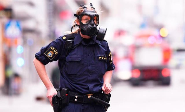 police officer work at the scene where a truck crashed into ahlens department store in central stockholm photo afp file