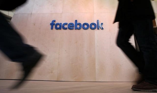 people walk in front of the facebook logo at the new facebook innovation hub during a preview media tour in berlin germany february 24 2016 photo reuters