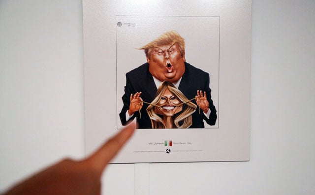 a picture taken on july 3 2017 shows a cartoon of us president donald j trump and first lady melania trump on display at an exhibition of the islamic republic 039 s 2017 international trumpism cartoon and caricature contest in the capital tehran photo afp