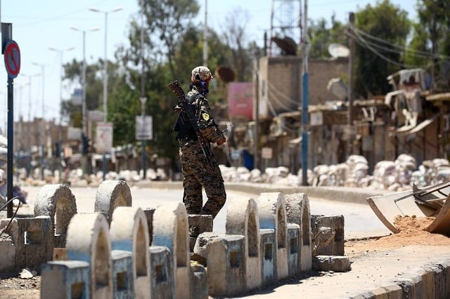 a member of the us backed syrian democratic forces sdf patrols a street in syrian town of tabqa in may 2017 as they advance their battle to the islamic state 039 s stronghold in nearby raqa photo afp a member of the us backed syrian democratic forces sdf patrols a street in syrian town of tabqa in may 2017 as they advance their battle to the islamic state 039 s stronghold in nearby raqa photo afp