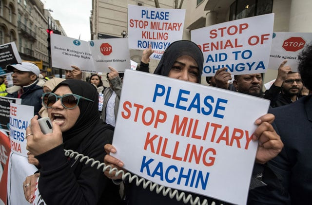 protesters hold placards and chant during a demonstration against myanmar 039 s de facto leader aung san suu kyi as she attends an event at the guildhall in the city of london on may 8 2017 photo afp protesters hold placards and chant during a demonstration against myanmar 039 s de facto leader aung san suu kyi as she attends an event at the guildhall in the city of london on may 8 2017 photo afp