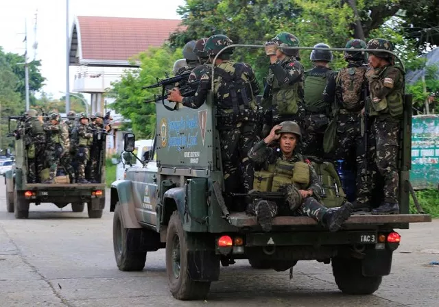 government soldiers are seen onboard military vehicles driving along the main road of amai pakpak as government troops continue their assault against insurgents from maute group who has taken over large parts of the marawi city philippines photo reuters government soldiers are seen onboard military vehicles driving along the main road of amai pakpak as government troops continue their assault against insurgents from maute group who has taken over large parts of the marawi city philippines photo reuters