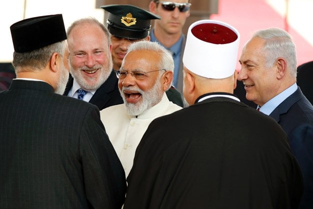 israeli prime minister benjamin netanyahu r introduces his indian counterpart narendra modi c to religious officials during an official ceremony at the ben gurion international airport near tel aviv on july 4 2017 photo afp