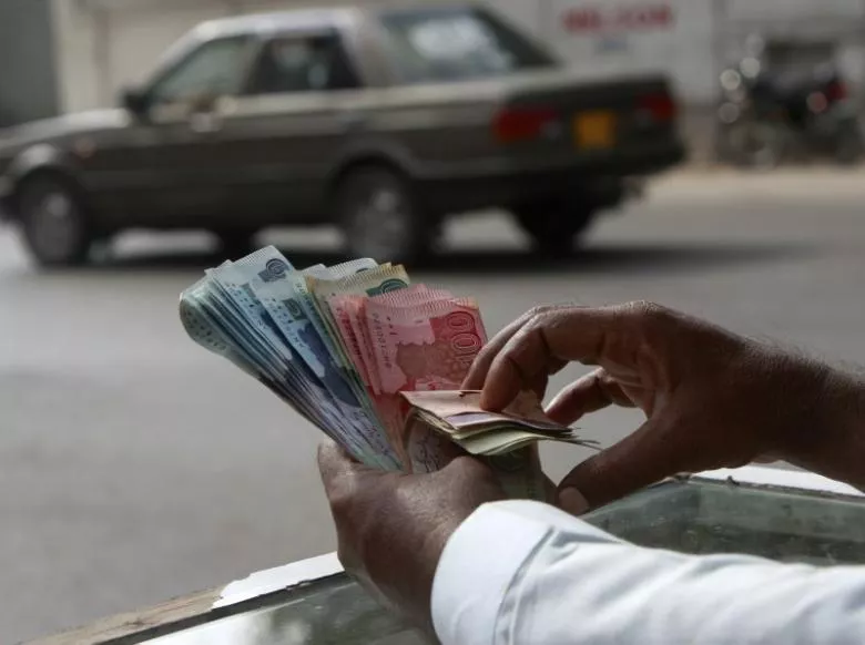 a money changer counts pakistani rupee notes in karachi photo reuters a money changer counts pakistani rupee notes in karachi photo reuters