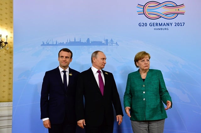 german chancellor angela merkel french president emmanuel macron l and russia 039 s president vladimir putin c pose for a picture prior to a meeting during the g20 summit in hamburg northern germany on july 8 2017 leaders of the world 039 s top economies gather from july 7 to 8 2017 in germany for likely the stormiest g20 summit in years with disagreements ranging from wars to climate change and global trade photo afp german chancellor angela merkel french president emmanuel macron l and russia 039 s president vladimir putin c pose for a picture prior to a meeting during the g20 summit in hamburg northern germany on july 8 2017 leaders of the world 039 s top economies gather from july 7 to 8 2017 in germany for likely the stormiest g20 summit in years with disagreements ranging from wars to climate change and global trade photo afp