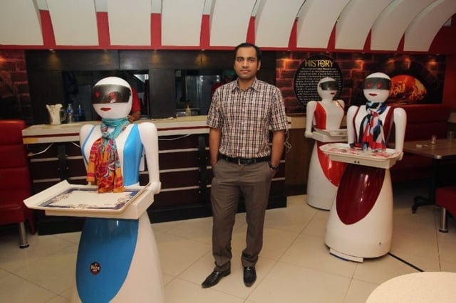 in this photograph taken on july 4 2017 pakistani engineer osama jafari c poses with robot waitresses annie l rabia r and jennie background at his pizza restaurant in multan photo afp in this photograph taken on july 4 2017 pakistani engineer osama jafari c poses with robot waitresses annie l rabia r and jennie background at his pizza restaurant in multan photo afp