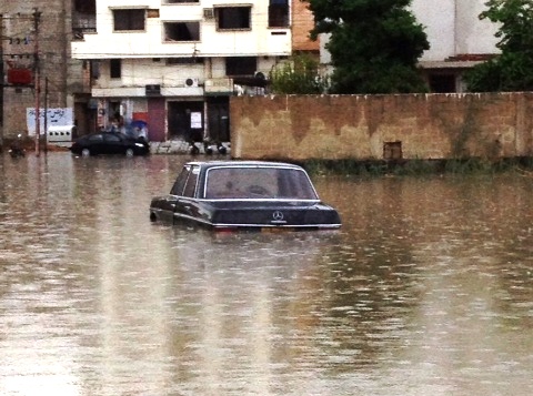 a car submerged in rain water photo express