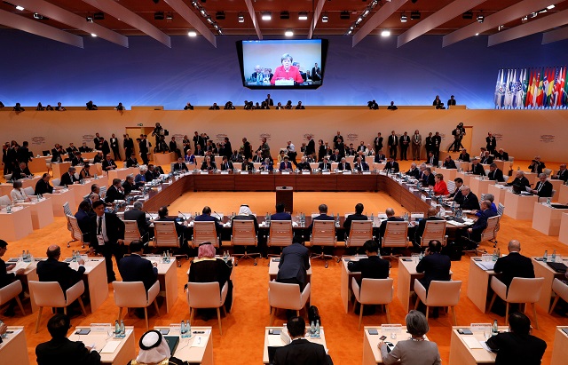 general view of the discussion table while german chancellor angela merkel is seen on the screen above during the g20 leaders summit in hamburg germany photo reuters