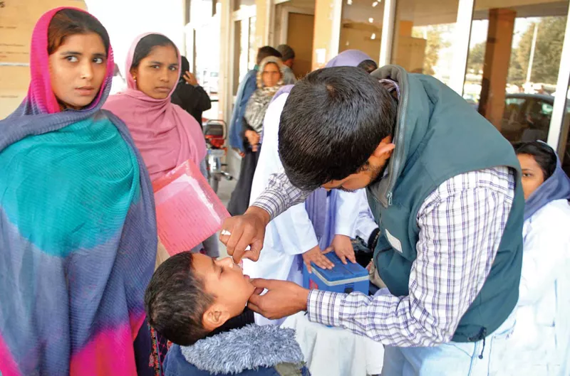 a health worker administers a polio drop to a child in rawalpindi photo file a health worker administers a polio drop to a child in rawalpindi photo file