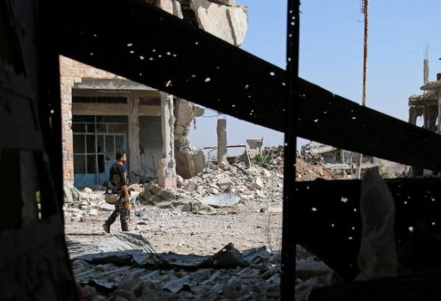 a free syrian army fighter carries his weapon as he walks past damaged buildings in a rebel held part of the southern city of daraa syria july 9 2017 photo reuters a free syrian army fighter carries his weapon as he walks past damaged buildings in a rebel held part of the southern city of daraa syria july 9 2017 photo reuters