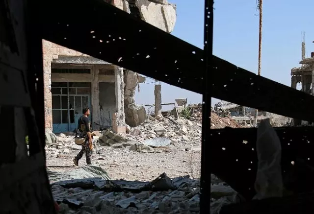 a free syrian army fighter carries his weapon as he walks past damaged buildings in a rebel held part of the southern city of daraa syria july 9 2017 photo reuters a free syrian army fighter carries his weapon as he walks past damaged buildings in a rebel held part of the southern city of daraa syria july 9 2017 photo reuters