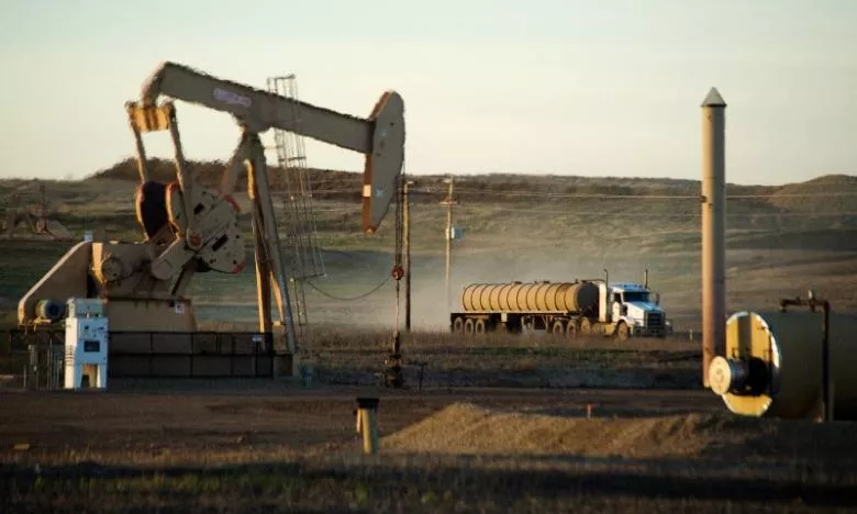 a service truck drives past and oil well photo reuters a service truck drives past and oil well photo reuters