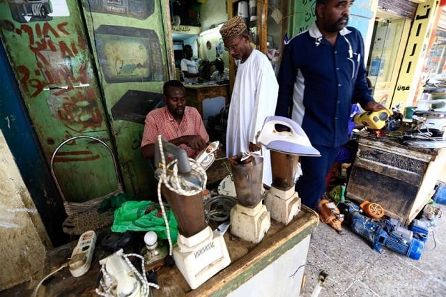 a man waits as a worker repairs an iron at a market in khartoum sudan january 14 2017 photo reuters a man waits as a worker repairs an iron at a market in khartoum sudan january 14 2017 photo reuters