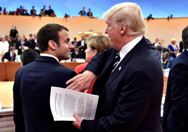 us president donald trump claps the shoulder of french president emmanuel macron at the start of the first working session photo reuters us president donald trump claps the shoulder of french president emmanuel macron at the start of the first working session photo reuters