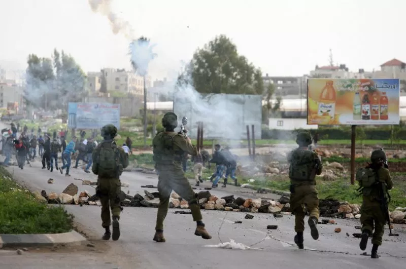 israeli soldiers fire tear gas canisters towards palestinian protestors during clashes near the west bank city of jenin photo afp israeli soldiers fire tear gas canisters towards palestinian protestors during clashes near the west bank city of jenin photo afp