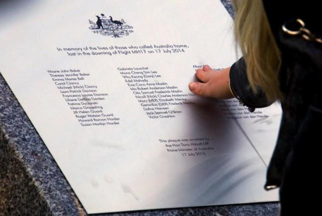 a relative of an australian victim of malaysia airlines jet mh17 touches a memorial that was unveiled outside parliament house in canberra australia july 17 2015 photo reuters file