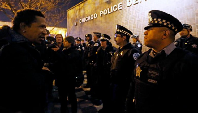 a demonstrator faces a line of police in front of the chicago police department during protests in chicago us photo reuters