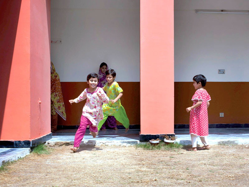 young girls run in the courtyard in the orphanage sisters gulshan 7 and khafifa 6 admire the new eid outfits given to them by ghonsla photo myra iqbal express