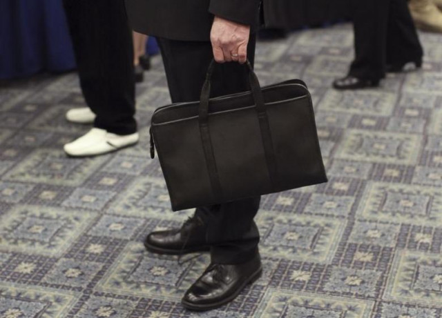 a man holds his briefcase photo reuters a man holds his briefcase photo reuters