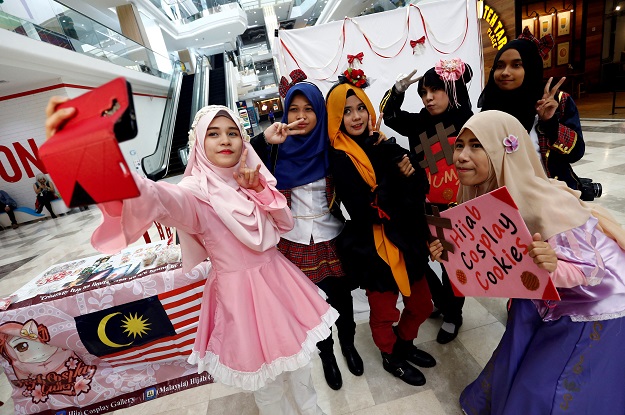 muslim women cosplayers take a selfie during a cosplay event at a mall in petaling jaya near kuala lumpur malaysia photo reuters