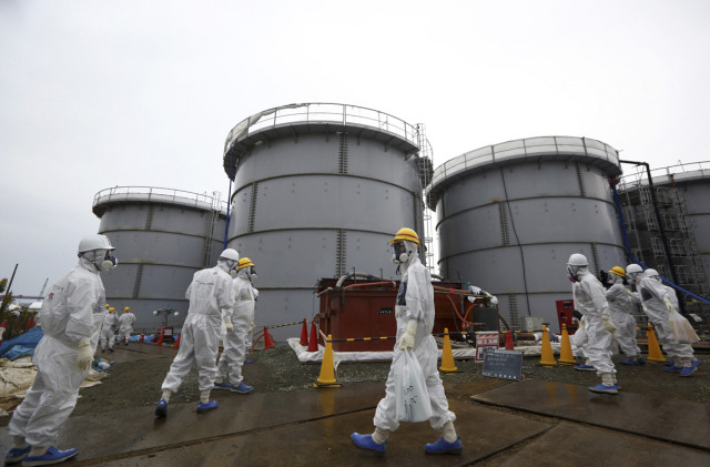 members of the media and tokyo electric power co employees wearing protective suits and masks walk past storage tanks for radioactive water in the h4 area at the tsunami crippled tepco fukushima daiichi nuclear power plant in fukushima prefecture in this file picture taken november 7 2013 photo reuters members of the media and tokyo electric power co employees wearing protective suits and masks walk past storage tanks for radioactive water in the h4 area at the tsunami crippled tepco fukushima daiichi nuclear power plant in fukushima prefecture in this file picture taken november 7 2013 photo reuters