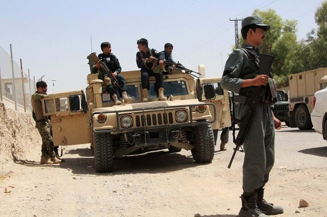 afghan security personnel sit on atop an armoured vehicles amid an ongoing battle with taliban militants in the gereshk district of helmand province on july 22 2017 a us airstrike has killed 16 policemen in afghanistan officials said july 22 the latest setback to washington 039 s efforts to bring peace to the war torn country the incident took place in helmand province on friday as afghan security forces attempted to clear a village of taliban militants salam afghan a police spokesman told afp photo afp