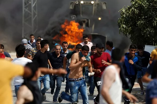 palestinian youths run from the path of an israeli army bulldozer during clashes in the village of kubar west of ramallah photo afp palestinian youths run from the path of an israeli army bulldozer during clashes in the village of kubar west of ramallah photo afp