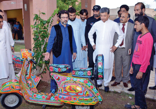 mayor anser aziz looks at a vespa scooter decorated with traditional truck art photo inp mayor anser aziz looks at a vespa scooter decorated with traditional truck art photo inp