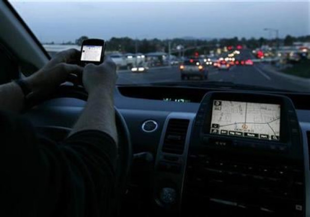 a driver uses his smart phone while in traffic photo reuters a driver uses his smart phone while in traffic photo reuters