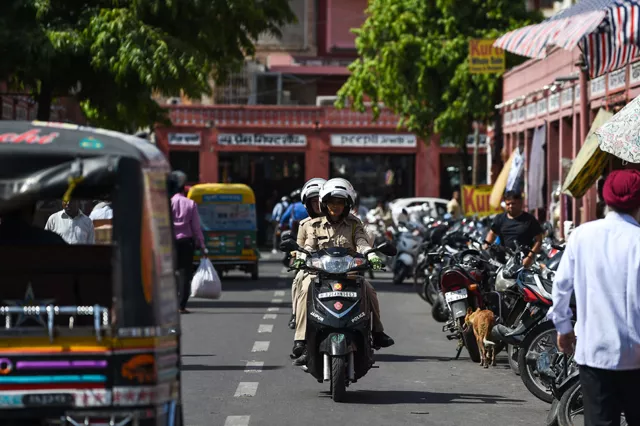 members of a newly launched female police patrol unit drive through the old market in jaipur all female police units are shaking up the male dominated force in conservative northwest india photo afp members of a newly launched female police patrol unit drive through the old market in jaipur all female police units are shaking up the male dominated force in conservative northwest india photo afp