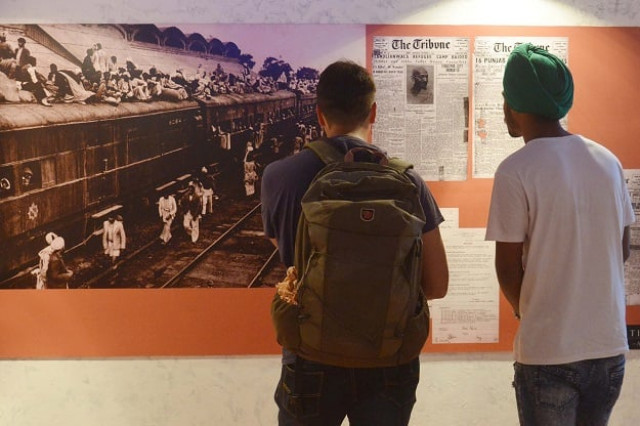 visitors look at photographs and newspaper clippings at the partition museum in amritsar india photo afp visitors look at photographs and newspaper clippings at the partition museum in amritsar india photo afp