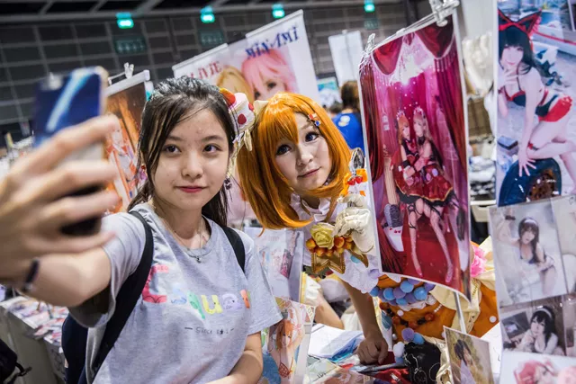 a cosplay fan l poses for a photo at a booth selling cosplay accessories as comic book and gaming fans attend the annual ani com and games fair in hong kong on july 28 2017 photo afp