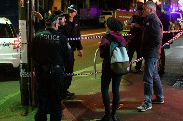 police speak to passersby as they man a check point in the inner sydney suburb of surry hills photo afp police speak to passersby as they man a check point in the inner sydney suburb of surry hills photo afp
