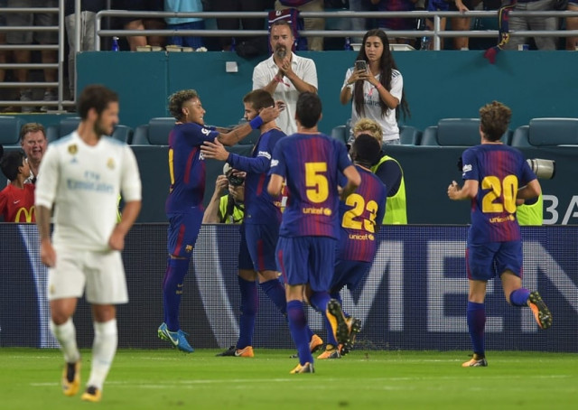 neymar l of barcelona greets teammate gerard pique c in celebration following pique 039 s his game winning goal against real madrid during their international champions cup football match at hard rock stadium on july 29 2017 in miami florida photo afp neymar l of barcelona greets teammate gerard pique c in celebration following pique 039 s his game winning goal against real madrid during their international champions cup football match at hard rock stadium on july 29 2017 in miami florida photo afp