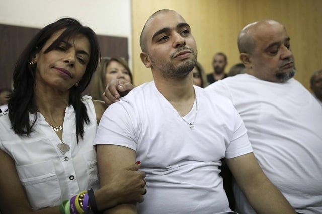 israeli soldier elor azaria c who shot dead a wounded palestinian assailant in march 2016 is embraced by his mother oshra l during a hearing at a military court in tel aviv on july 30 2017 judges were expected to rule on an appeal by an israeli soldier convicted of manslaughter and sentenced to 18 months in prison for shooting dead a prone palestinian assailant a case that has divided the country photo afp israeli soldier elor azaria c who shot dead a wounded palestinian assailant in march 2016 is embraced by his mother oshra l during a hearing at a military court in tel aviv on july 30 2017 judges were expected to rule on an appeal by an israeli soldier convicted of manslaughter and sentenced to 18 months in prison for shooting dead a prone palestinian assailant a case that has divided the country photo afp