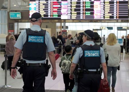 australia federal police officers patrol the security lines at sydney 039 s domestic airport photo reuters