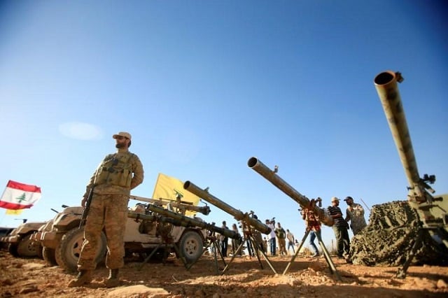 a hezbollah fighter stands in front of anti tank artillery at juroud arsal the syria lebanon border july 29 2017 photo reuters