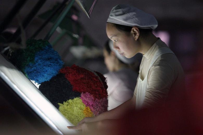 a woman works at a textile factory photo reuters